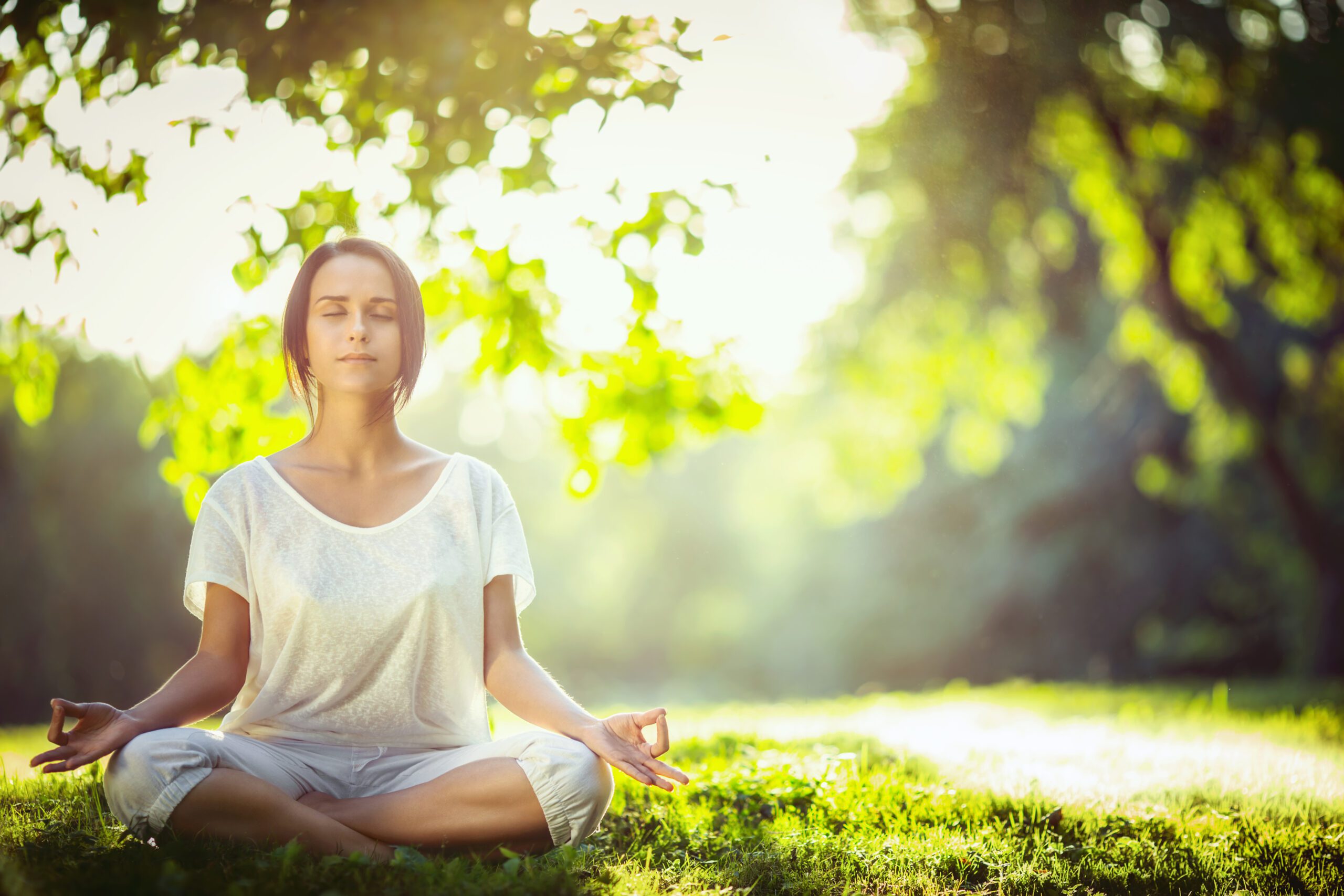Young girl meditating in the park