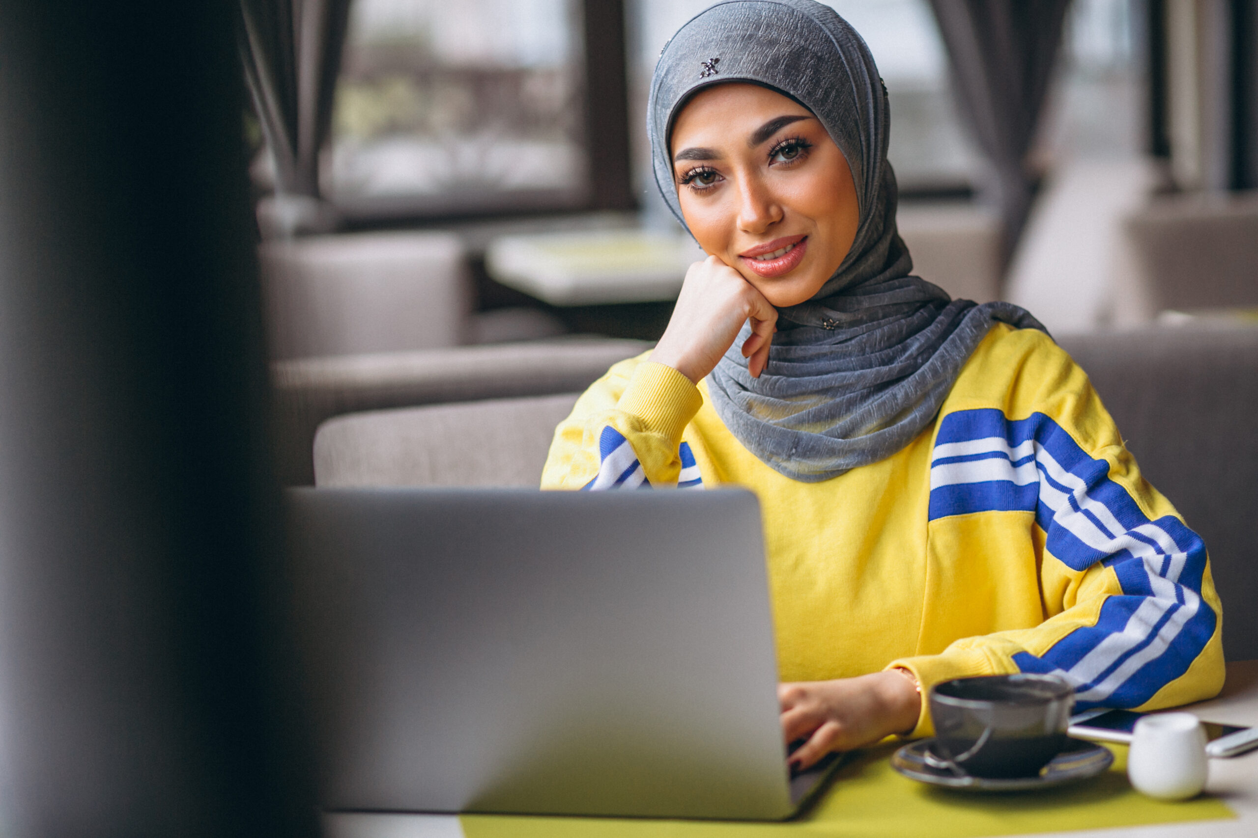 arabian-woman-hijab-inside-cafe-working-laptop-scaled.jpg